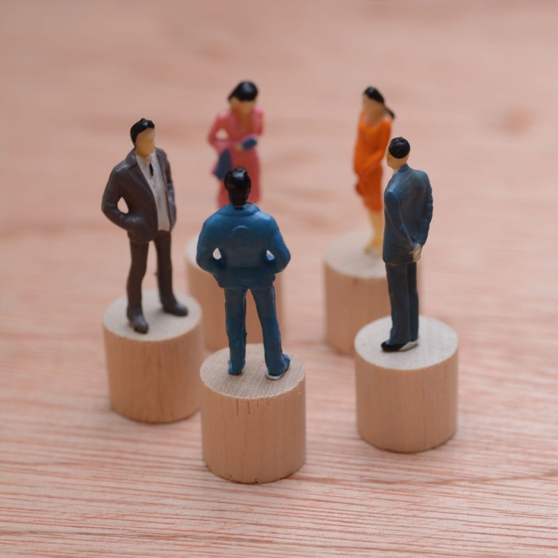 Miniature people connected with arrows. Networking concept. Copy space for text.